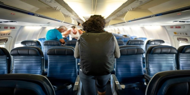 A person walking in an airplane
AI-generated content may be incorrect.
